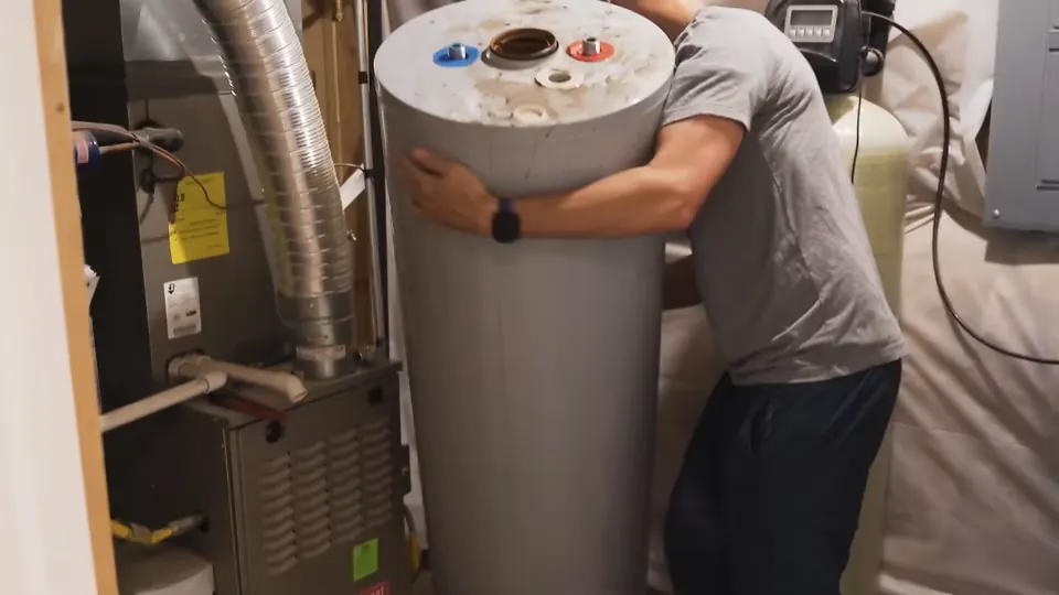 Technician handling a tank water heater